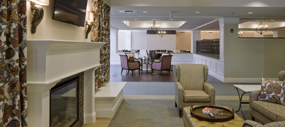 A cozy living room with an elegant seating area and a decorative fireplace.