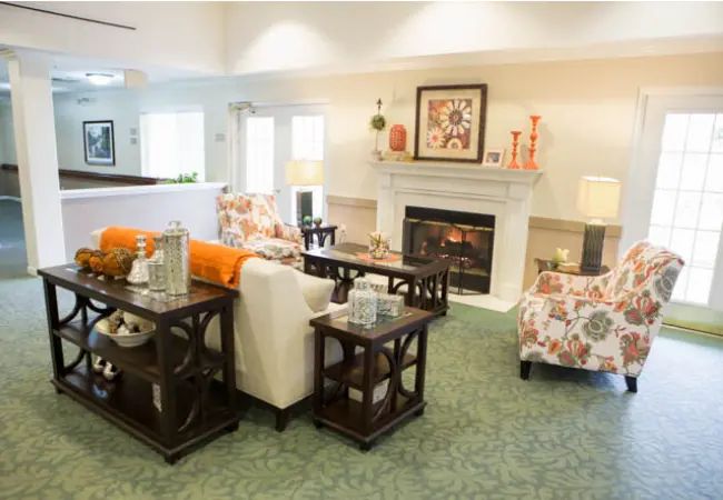 A cozy and well-decorated living room featuring a fireplace, comfortable seating, and elegant decor.