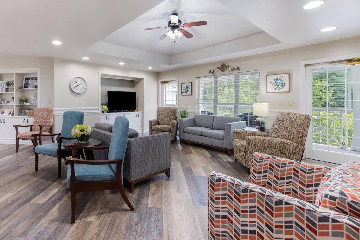 A cozy living room with comfortable seating, wood flooring, and natural light.