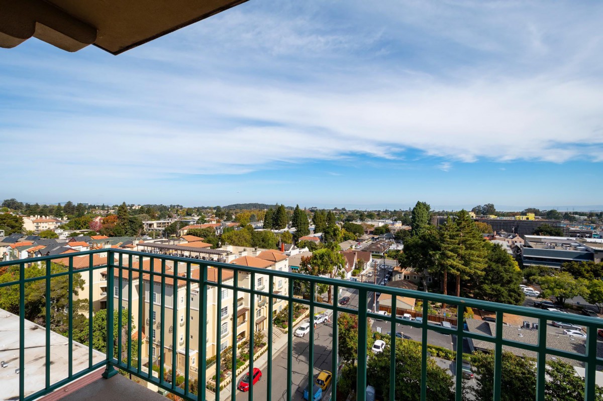 A scenic view from a balcony overlooking a residential neighborhood.