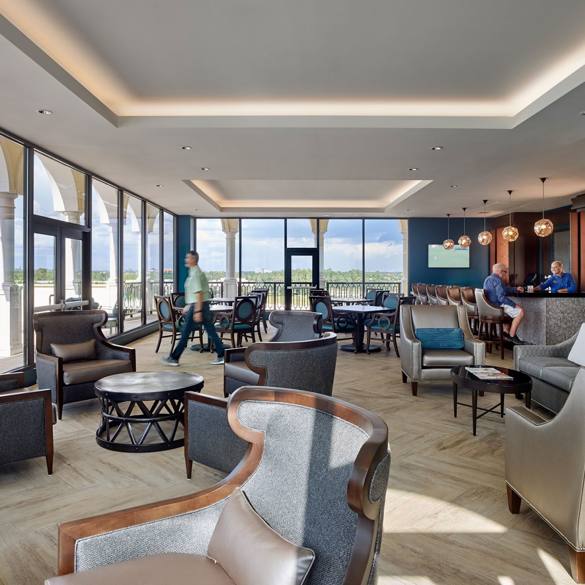 A modern lounge area with ample seating and large windows providing natural light.