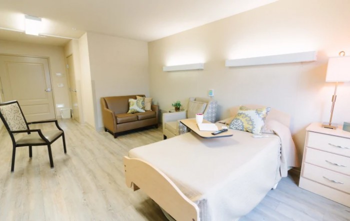 A cozy and modern bedroom interior with a bed, sofa, and elegant decor.
