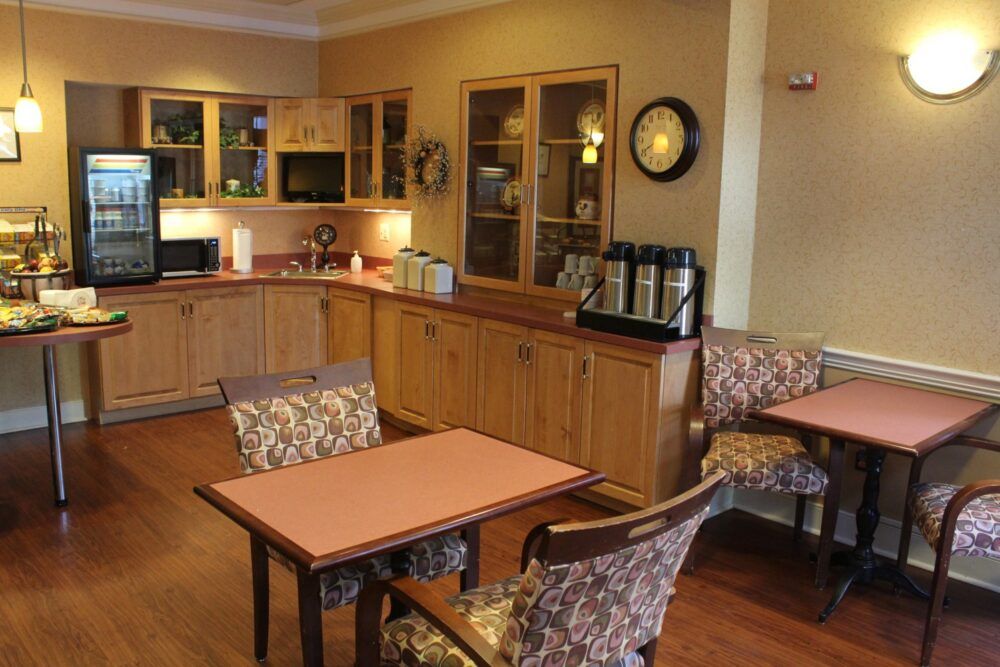 A cozy kitchen and dining area with wooden cabinets and a coffee station.