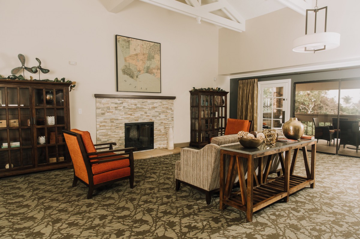 A cozy living room with a fireplace, armchairs, and elegant decor.