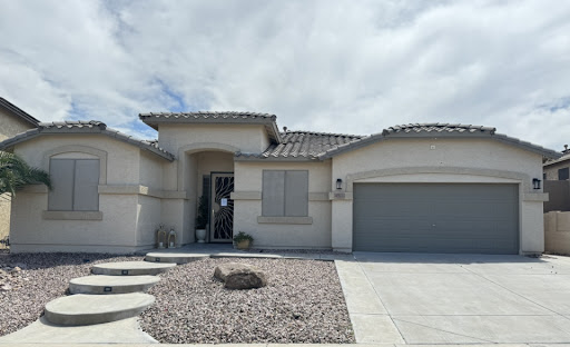 A modern residential home with a landscaped front yard and a garage.