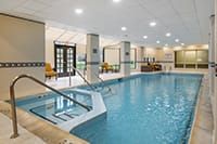 A serene indoor swimming pool with elegant decor and ambient lighting.