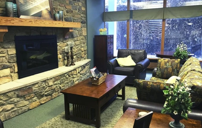 Cozy living room with a stone fireplace and comfortable seating.