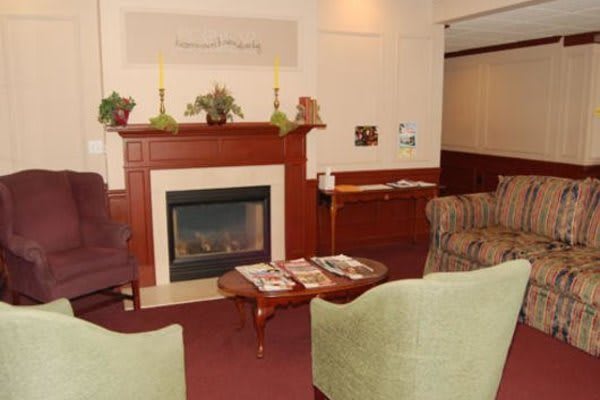 A cozy living room with a fireplace and comfortable seating.