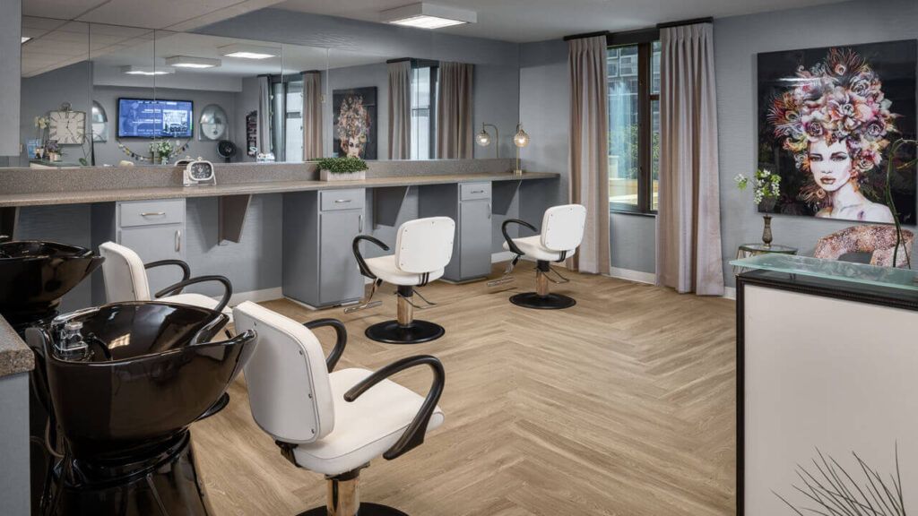 A sleek and modern hair salon interior with stylish chairs and mirrors.
