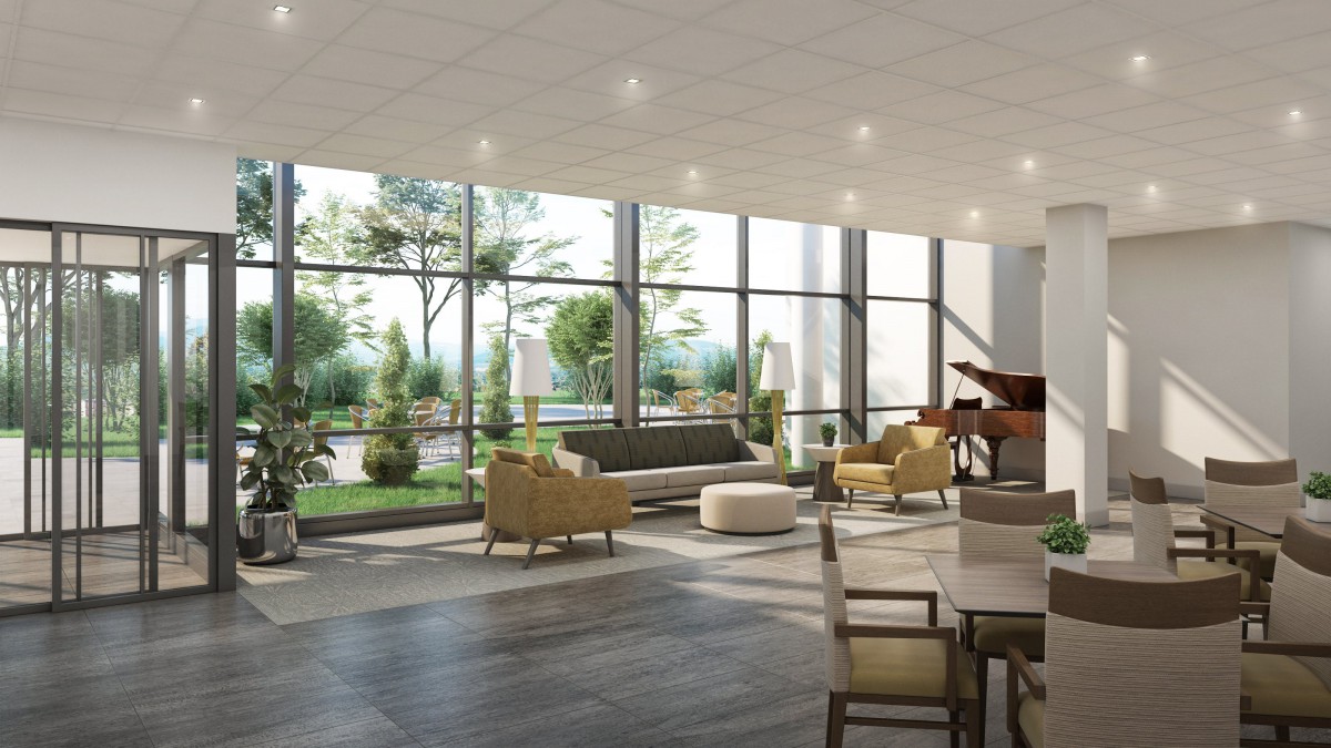A modern lobby with large windows, ample seating, and a piano, bathed in natural light.