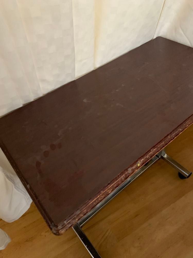 A vintage wooden table with a worn surface in an indoor setting.