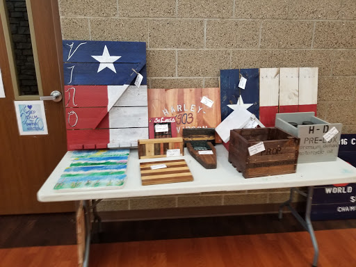 Handcrafted wooden items featuring the Texas flag, displayed at a craft fair.