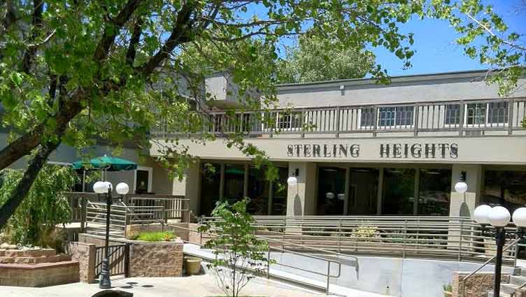 Exterior view of the Sterling Heights building surrounded by trees.