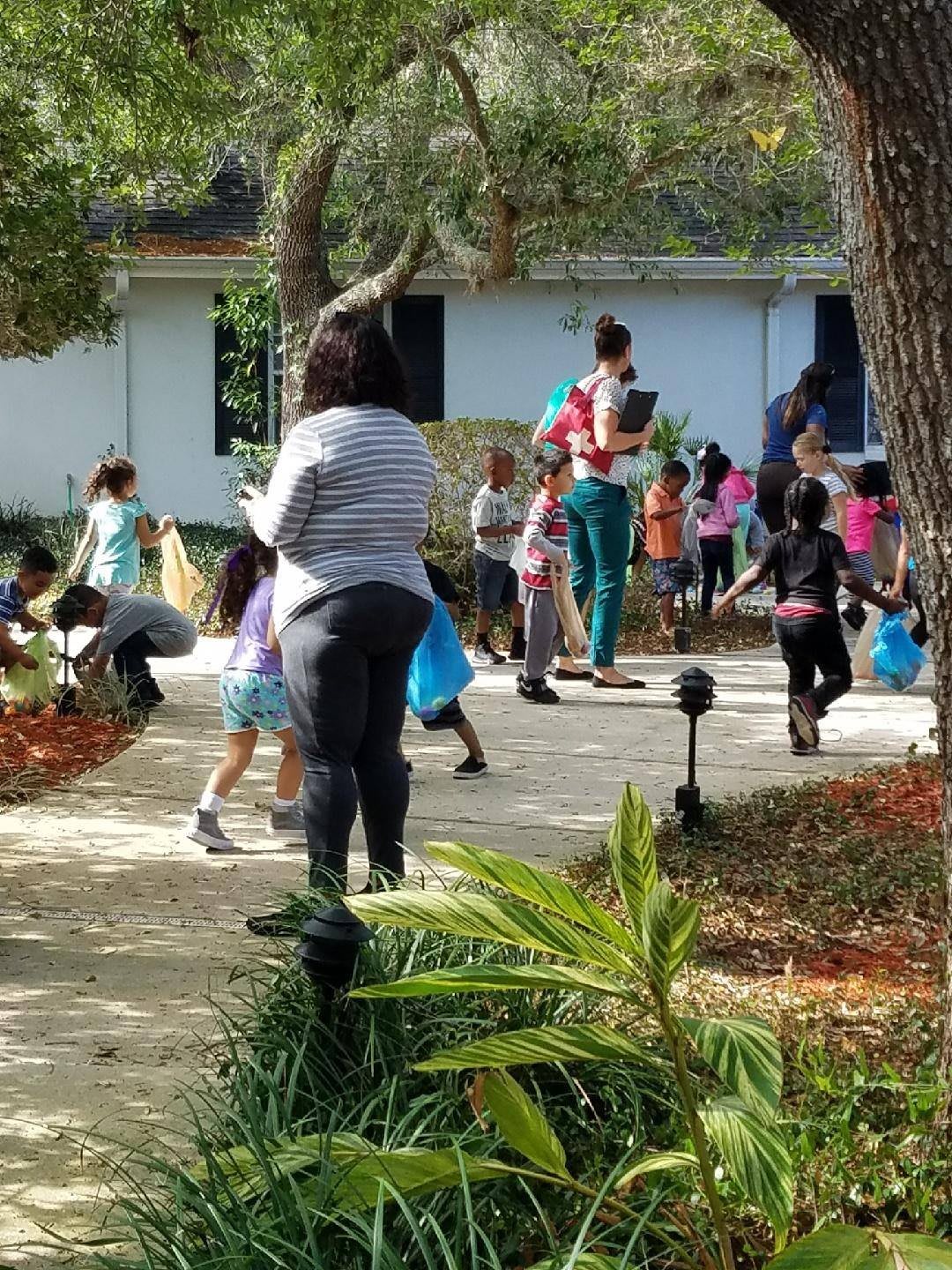 Children playing outside in a group setting.