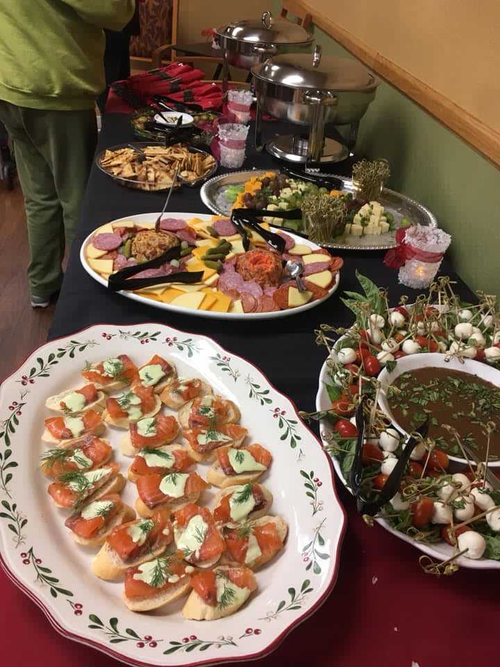 A variety of appetizers are displayed on a buffet table, ready for guests to enjoy.