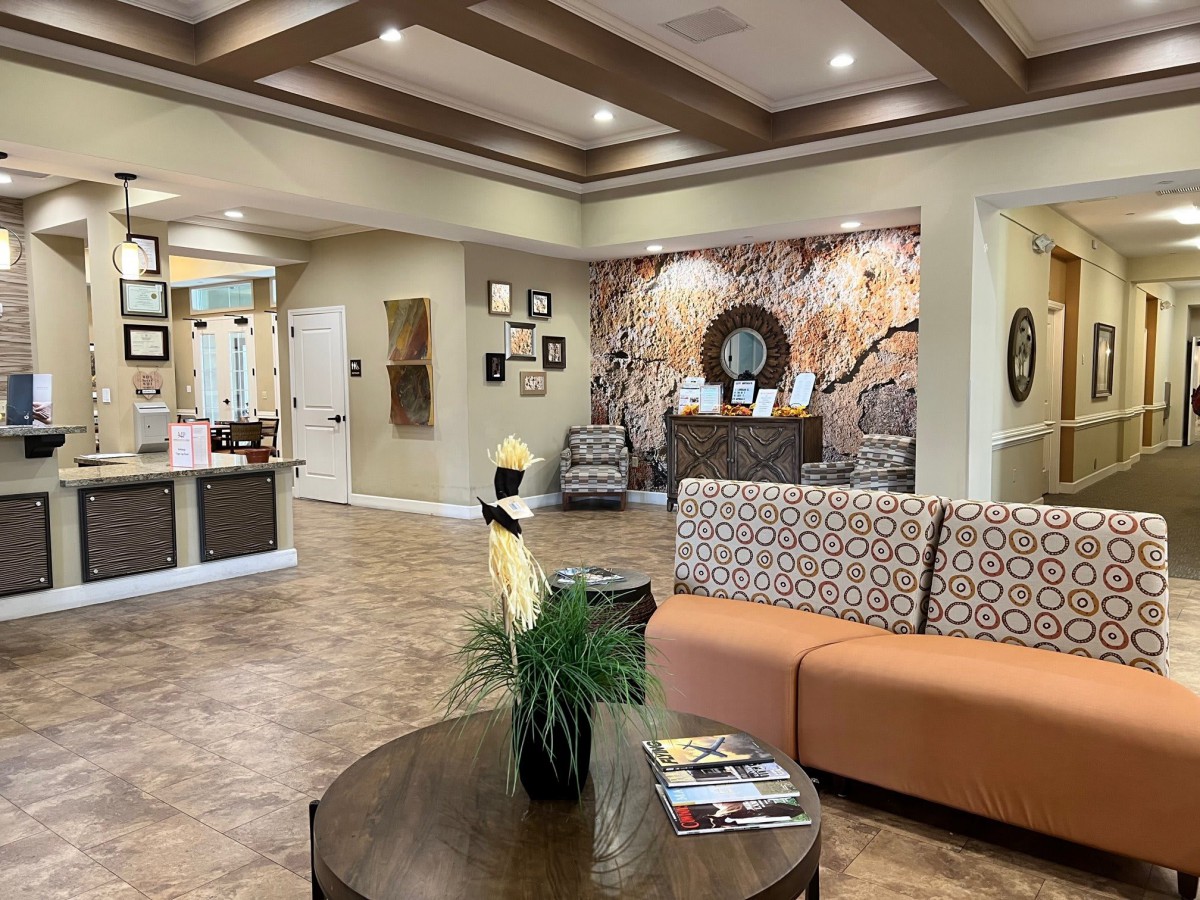 A well-decorated waiting room with comfortable seating and a reception desk.