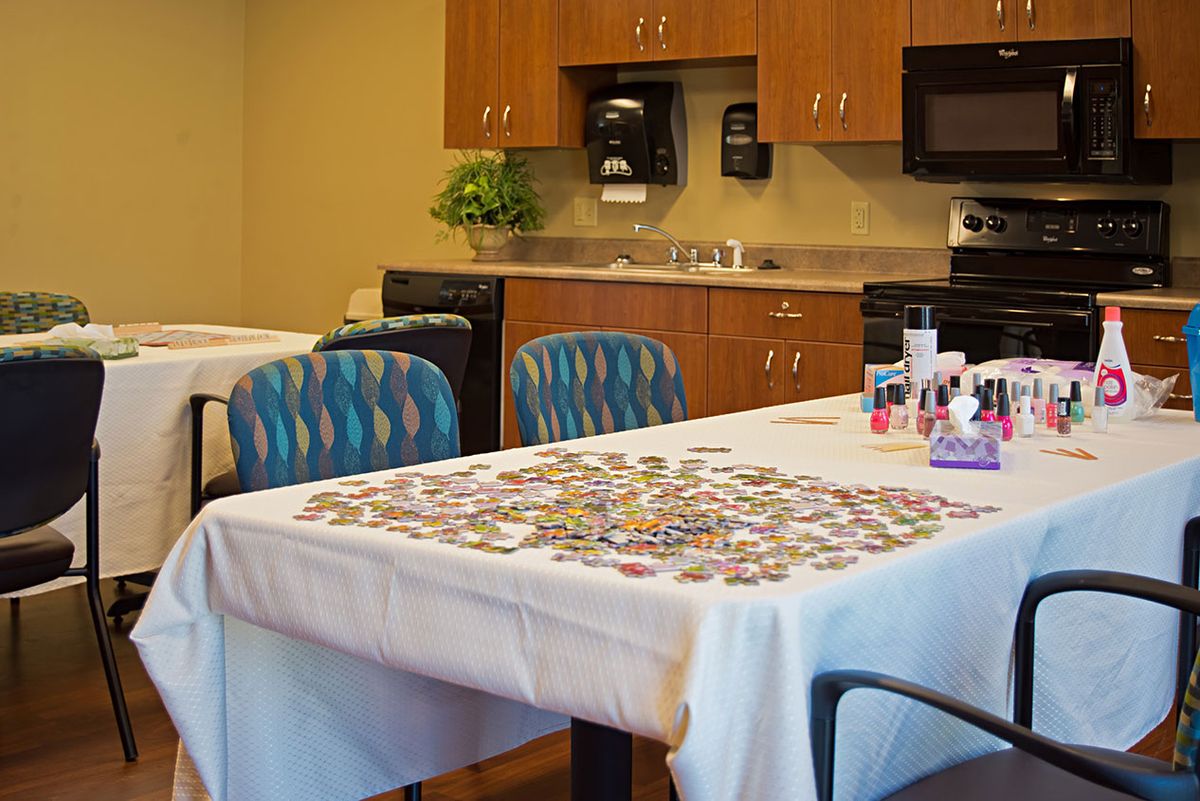 A community room with a table set up for puzzle activities.