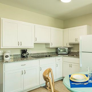 A cozy kitchen with white cabinets and modern appliances.