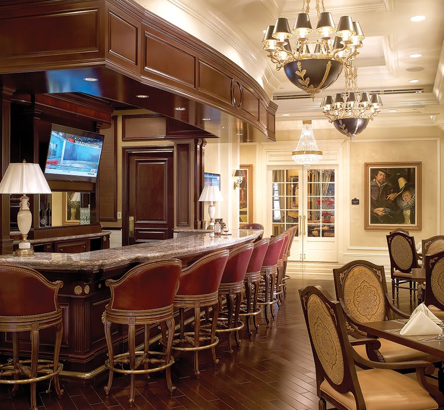 Elegant bar and dining area with luxurious interior design and chandeliers.