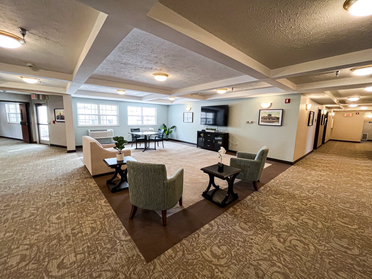 A spacious living room with comfortable seating and a large television.