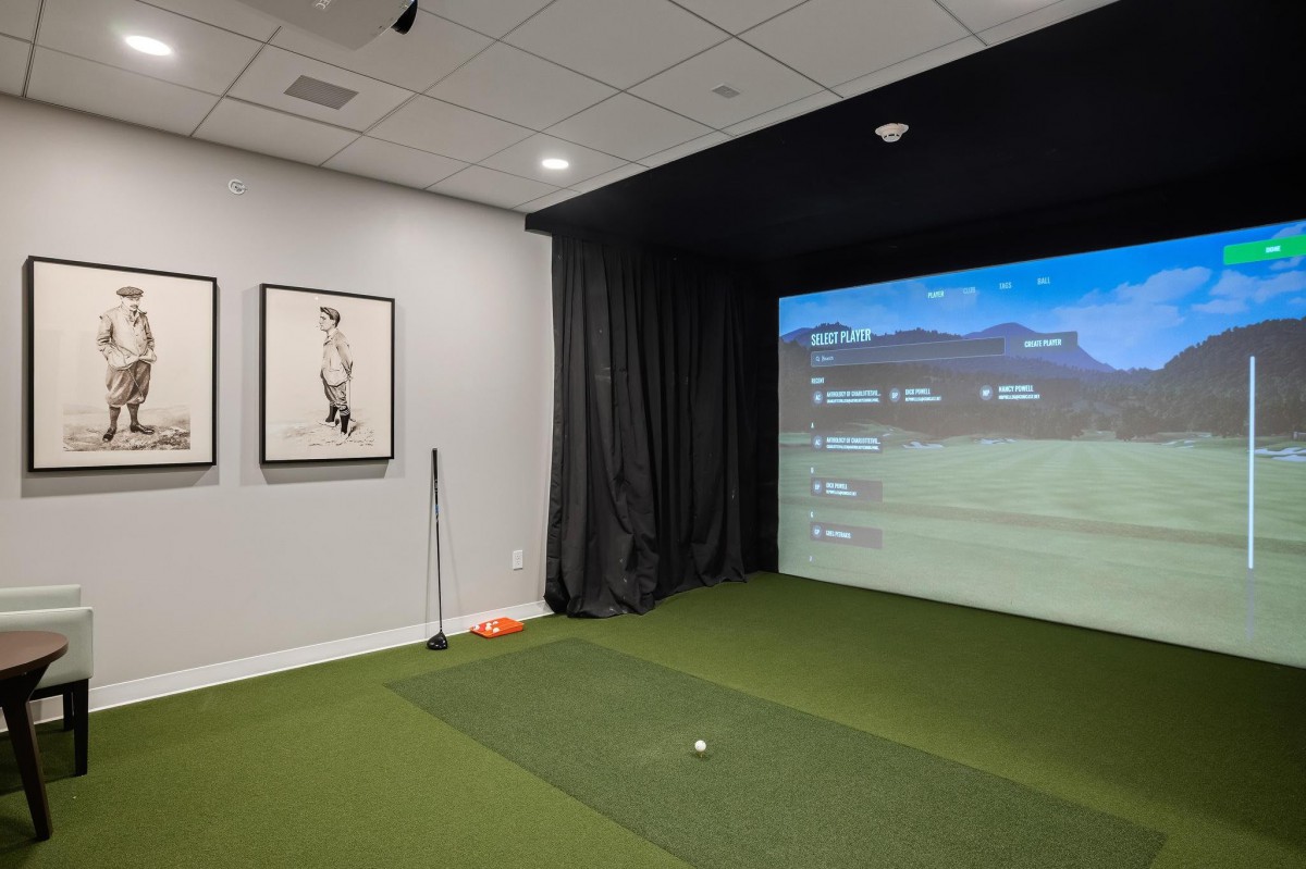 An indoor golf simulator setup for virtual golfing experiences.