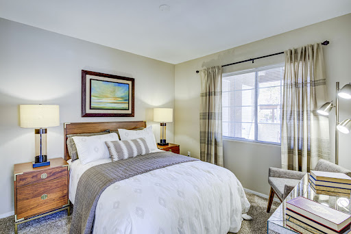 A cozy and well-decorated bedroom featuring a comfortable bed, stylish furniture, and a warm atmosphere.