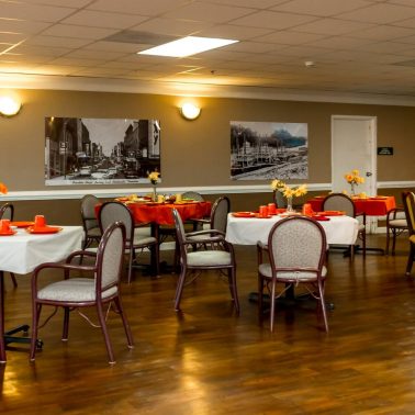 An inviting dining area with elegantly set tables and warm lighting.