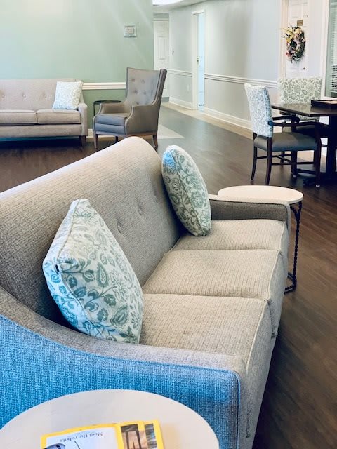 A cozy living room area featuring a comfortable sofa with decorative cushions.