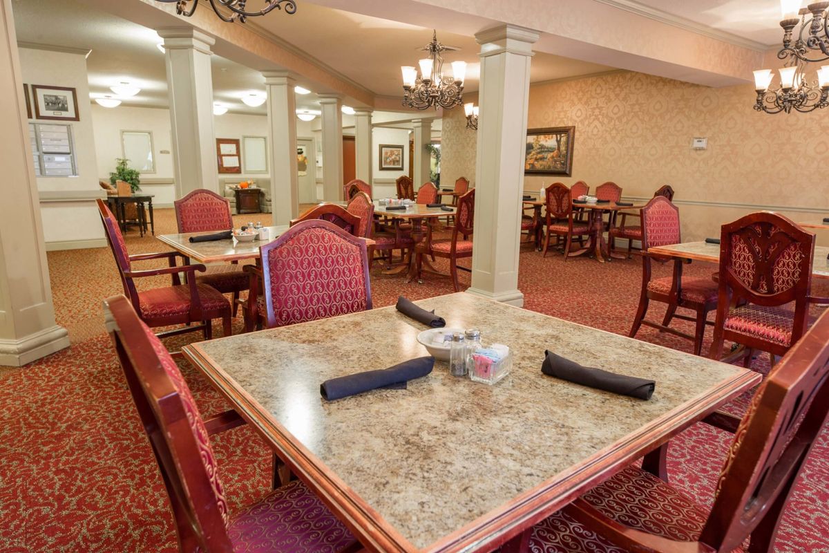 Elegant dining room with neatly arranged tables and chairs.