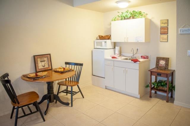 Cozy kitchen with a dining area featuring a round table and two chairs.