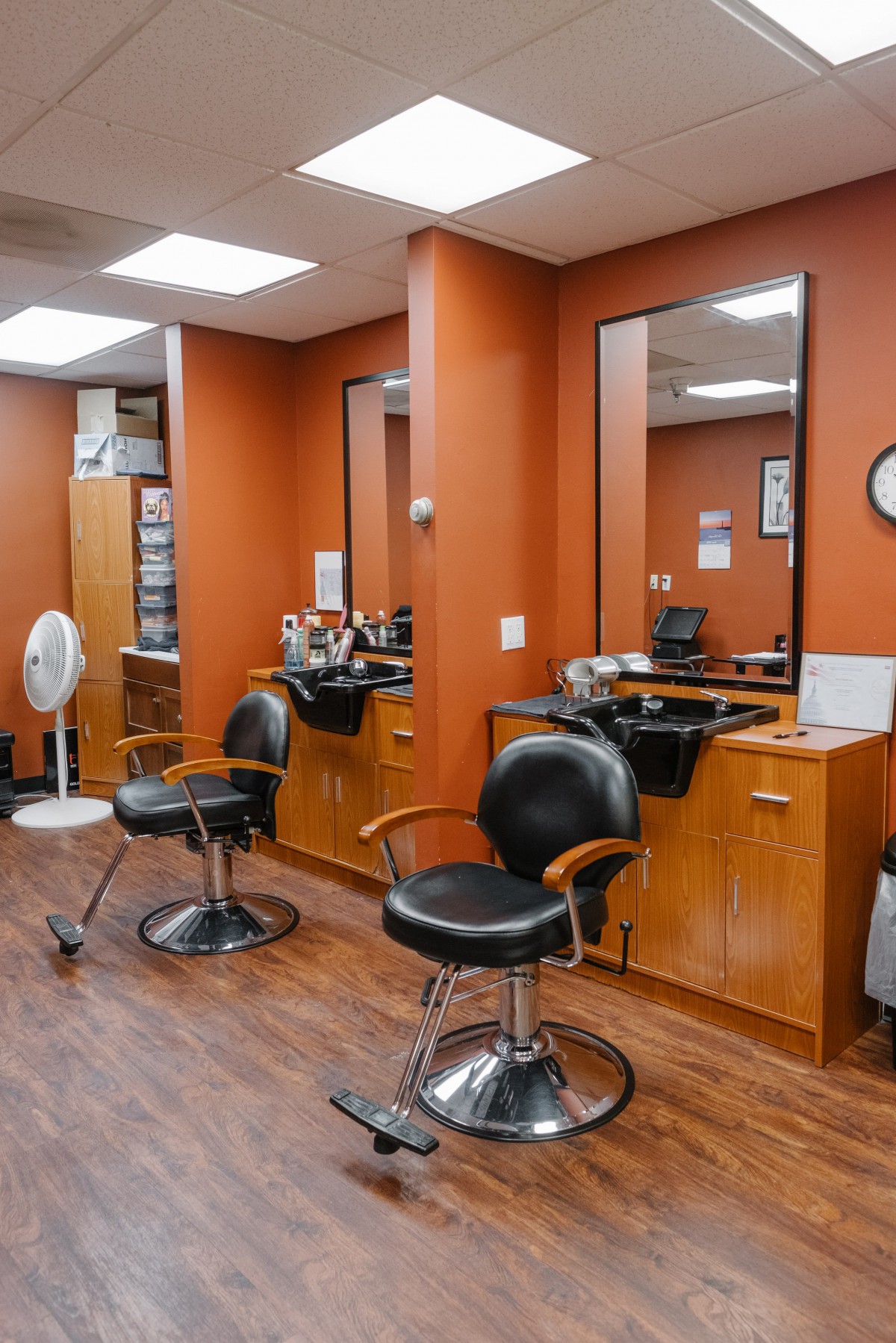 An interior view of a barbershop with empty chairs and mirrors.