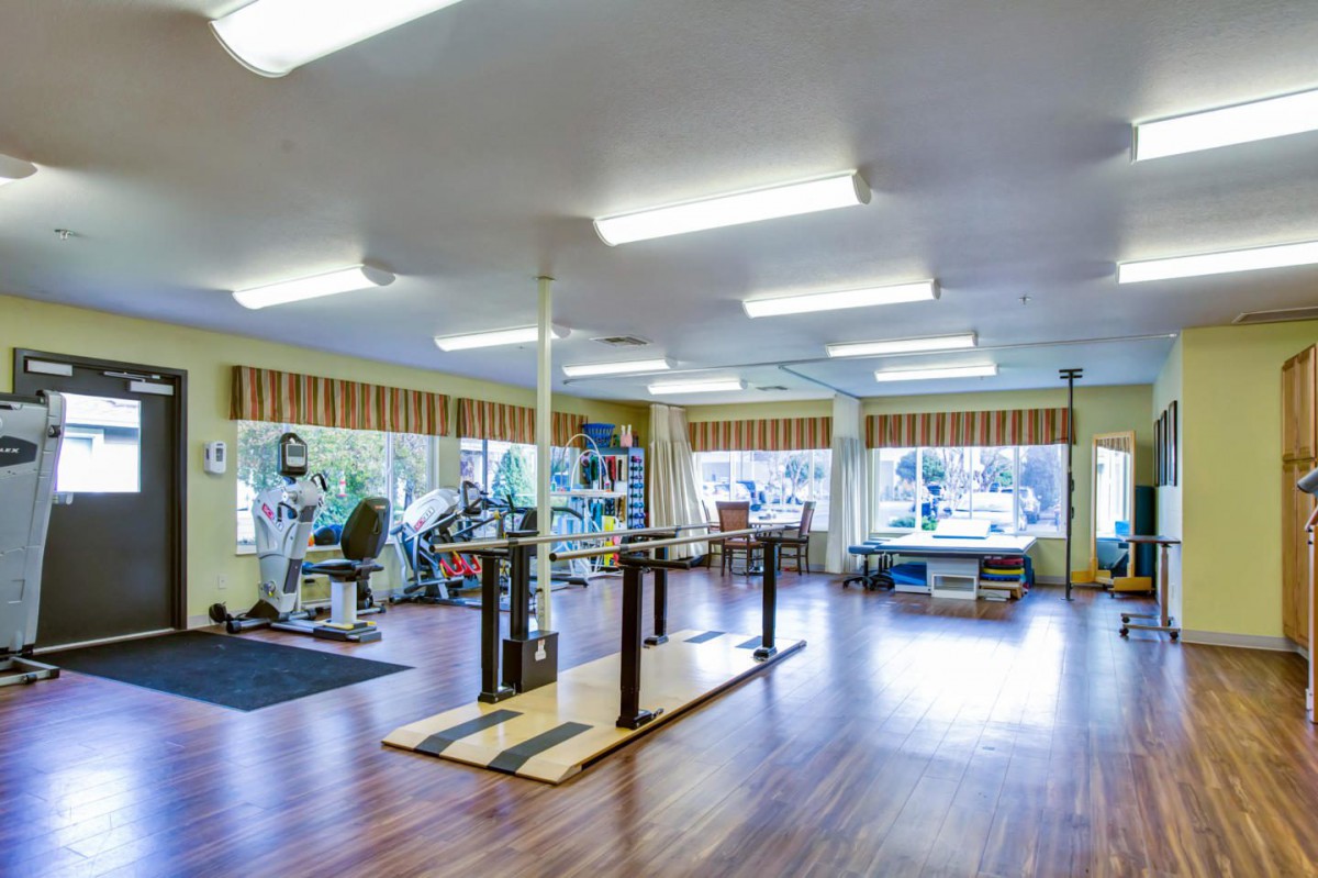A spacious gym featuring various exercise equipment for fitness enthusiasts.
