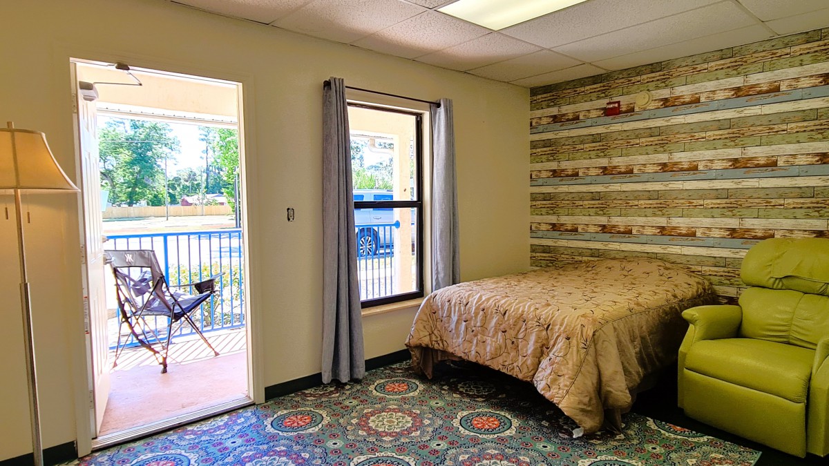 A cozy bedroom with rustic decor and a window view.