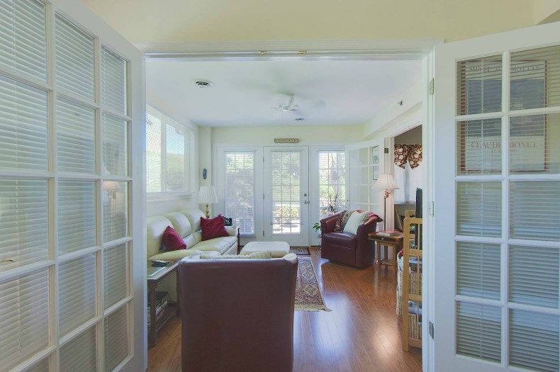 A cozy living room filled with natural light and comfortable seating.