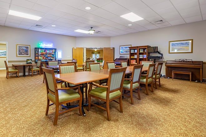 A spacious conference room with tables and chairs arranged for meetings.