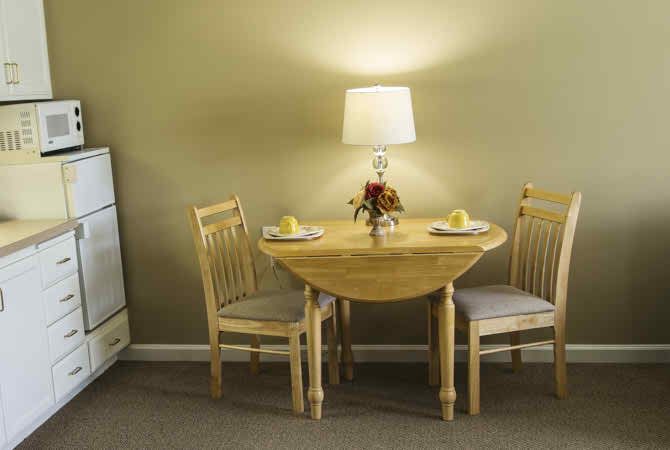 A cozy dining area with a round table set for two.