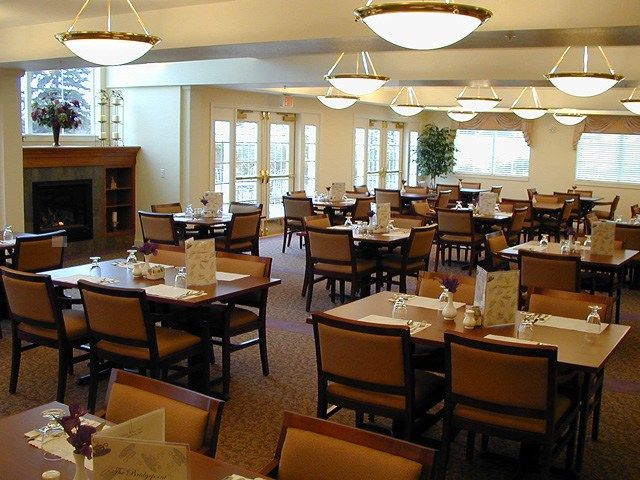 A spacious indoor dining area with neatly arranged tables and chairs.