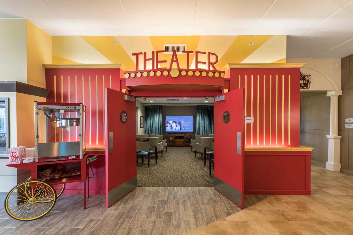 Entrance to a movie theater with red walls and an inviting atmosphere.