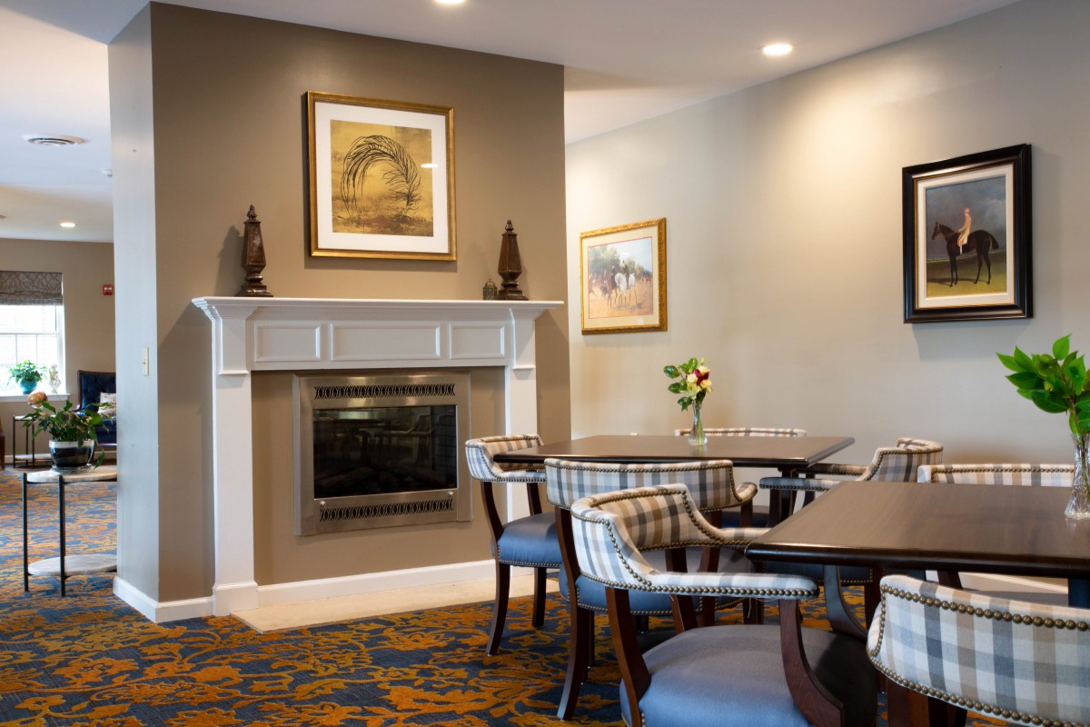 A cozy dining area with a fireplace and elegant decor.