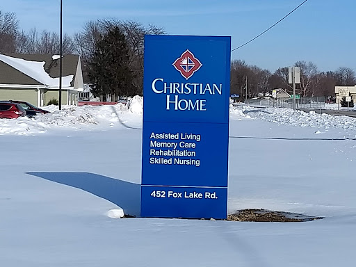Sign for Christian Home, offering various care services, surrounded by snow.