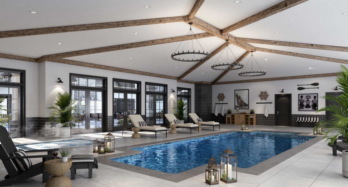 A luxurious indoor pool area with lounge chairs and elegant lighting.