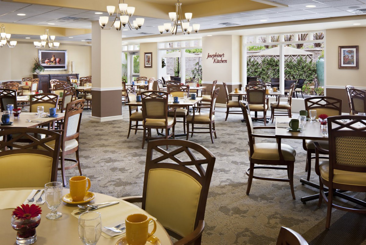 A spacious and elegant dining area with neatly arranged tables and chairs.