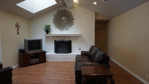 Cozy living room featuring a modern fireplace and comfortable seating.