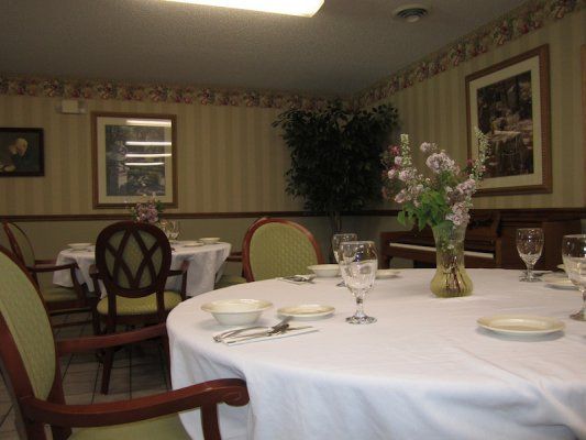 A neatly set dining room table with elegant decor.