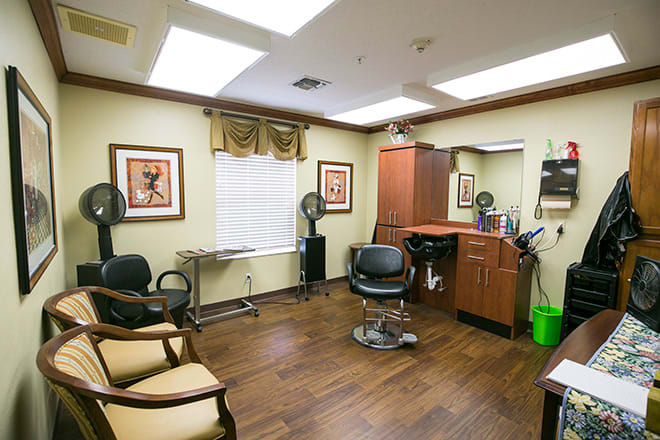 A cozy hair salon interior featuring a barber chair, mirror, and stylish decor.