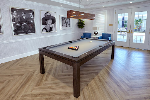 A stylish and modern recreation room featuring a pool table surrounded by elegant decor.