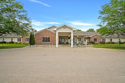 A welcoming entrance to a modern residential building with well-maintained landscaping.