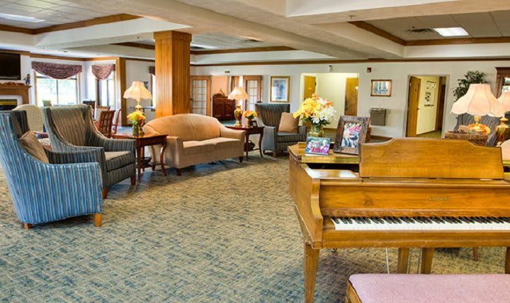 Elegant hotel lobby with a grand piano and comfortable seating.