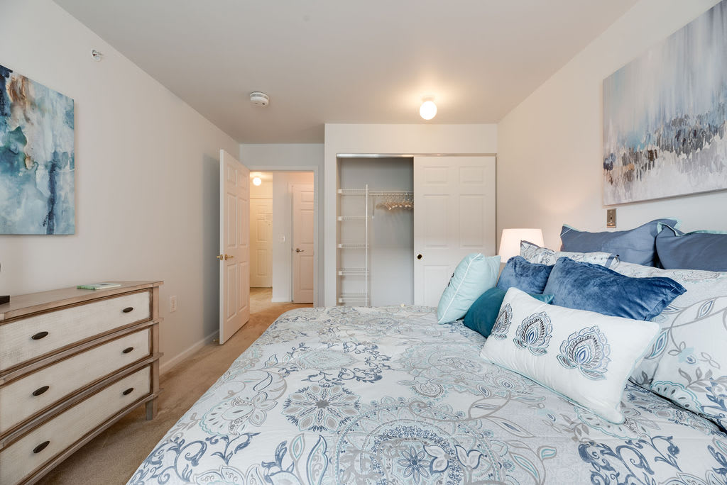 A modern bedroom with elegant bedding and stylish decor.