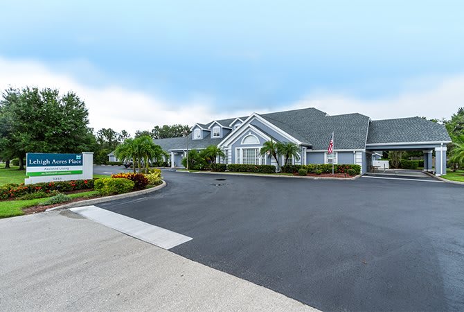 A well-maintained residential building with a spacious driveway and landscaped surroundings.